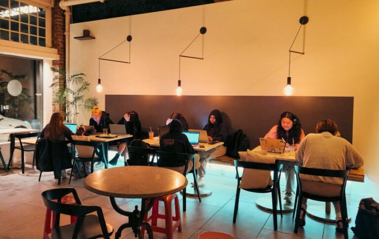 People working on laptops in a cafe
