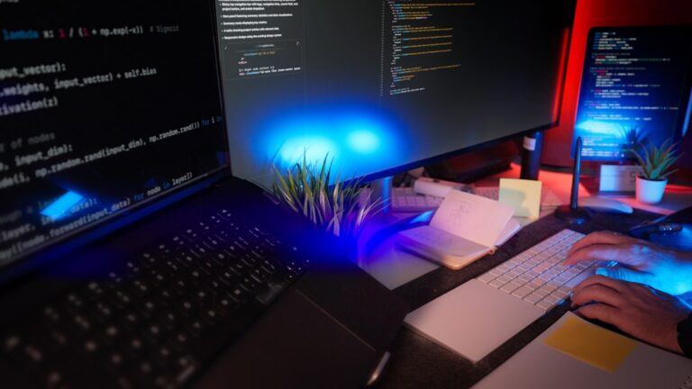 Developer workspace with laptop and multiple screens